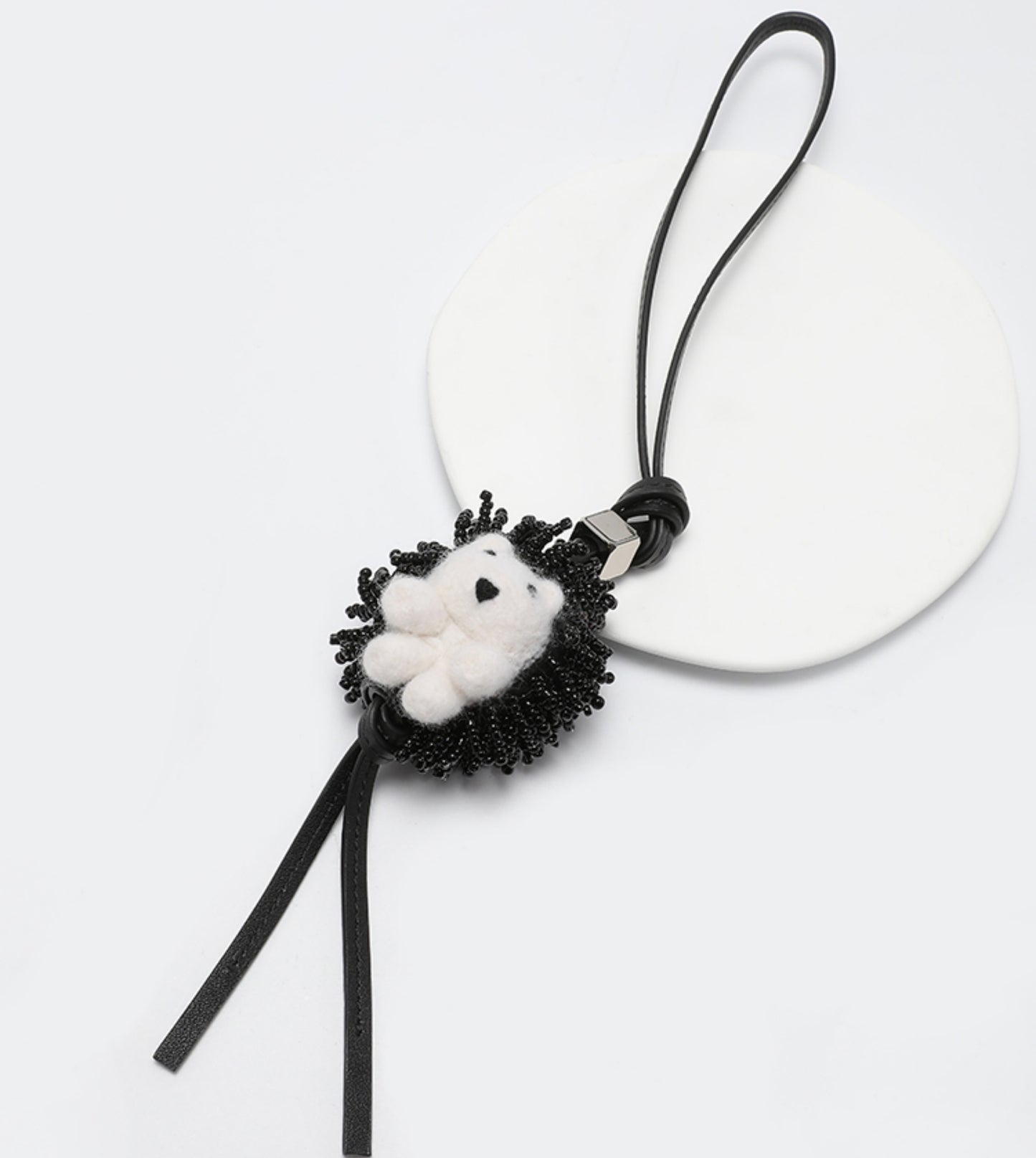 A fashionable handbag charm, handmade from genuine leather, featuring a cute animal design. It can be used as a keychain or a car accessory