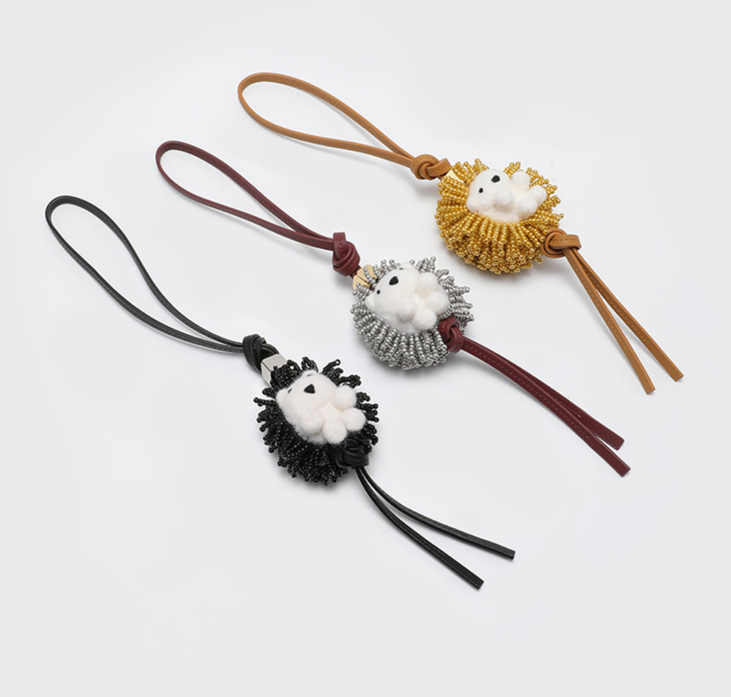 A fashionable handbag charm, handmade from genuine leather, featuring a cute animal design. It can be used as a keychain or a car accessory