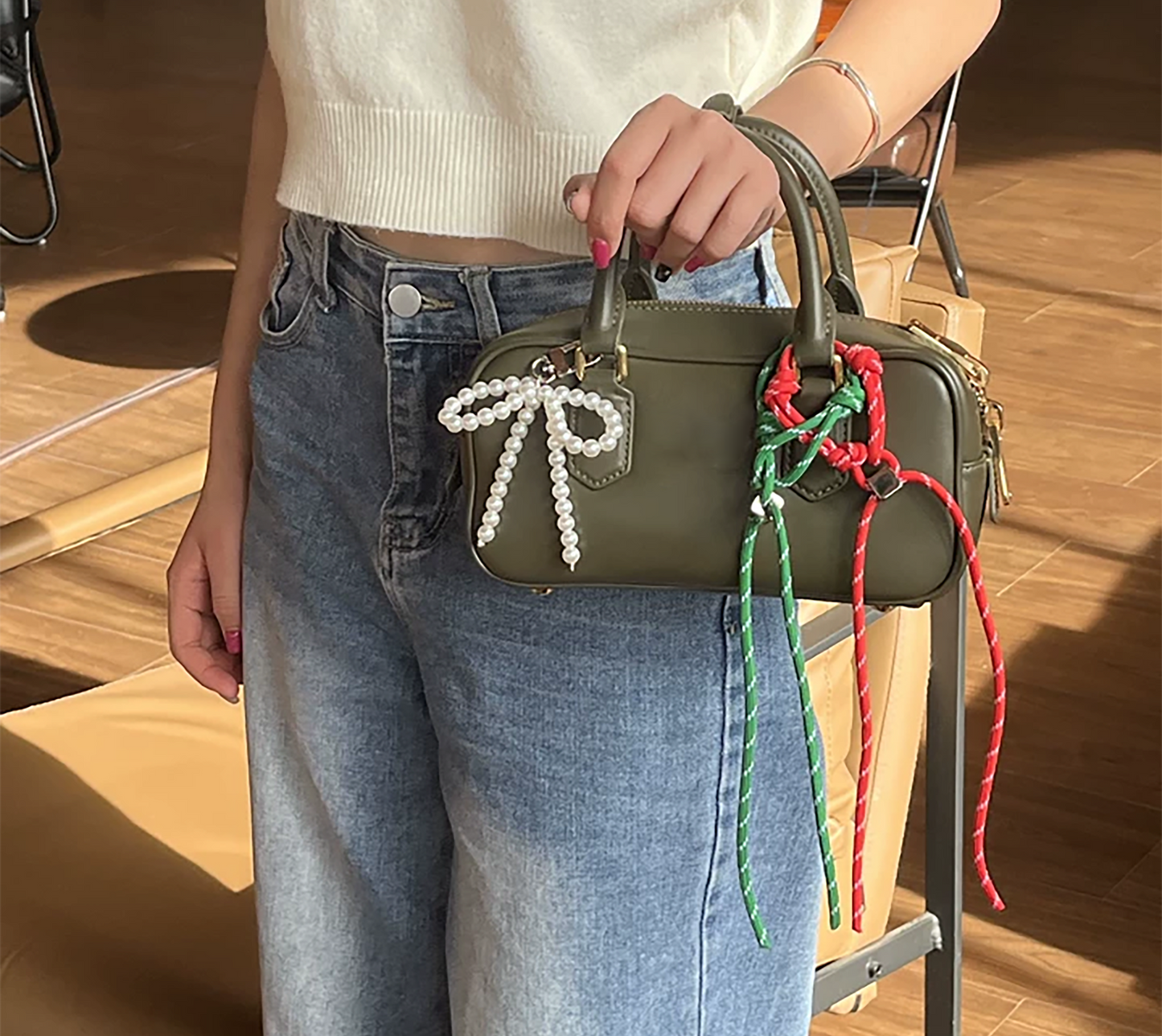 Arcadie matelassé nappa leather bag charm, pearl decorative accessory, bow-shaped keychain.