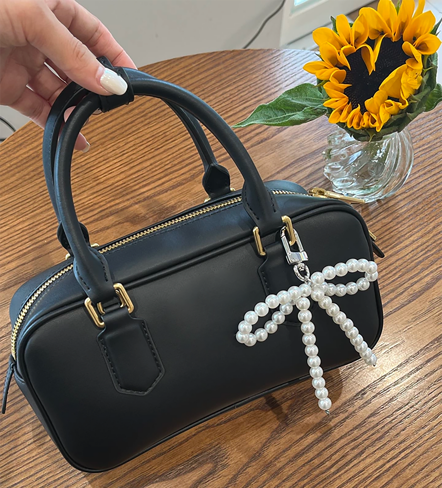 Arcadie matelassé nappa leather bag charm, pearl decorative accessory, bow-shaped keychain.