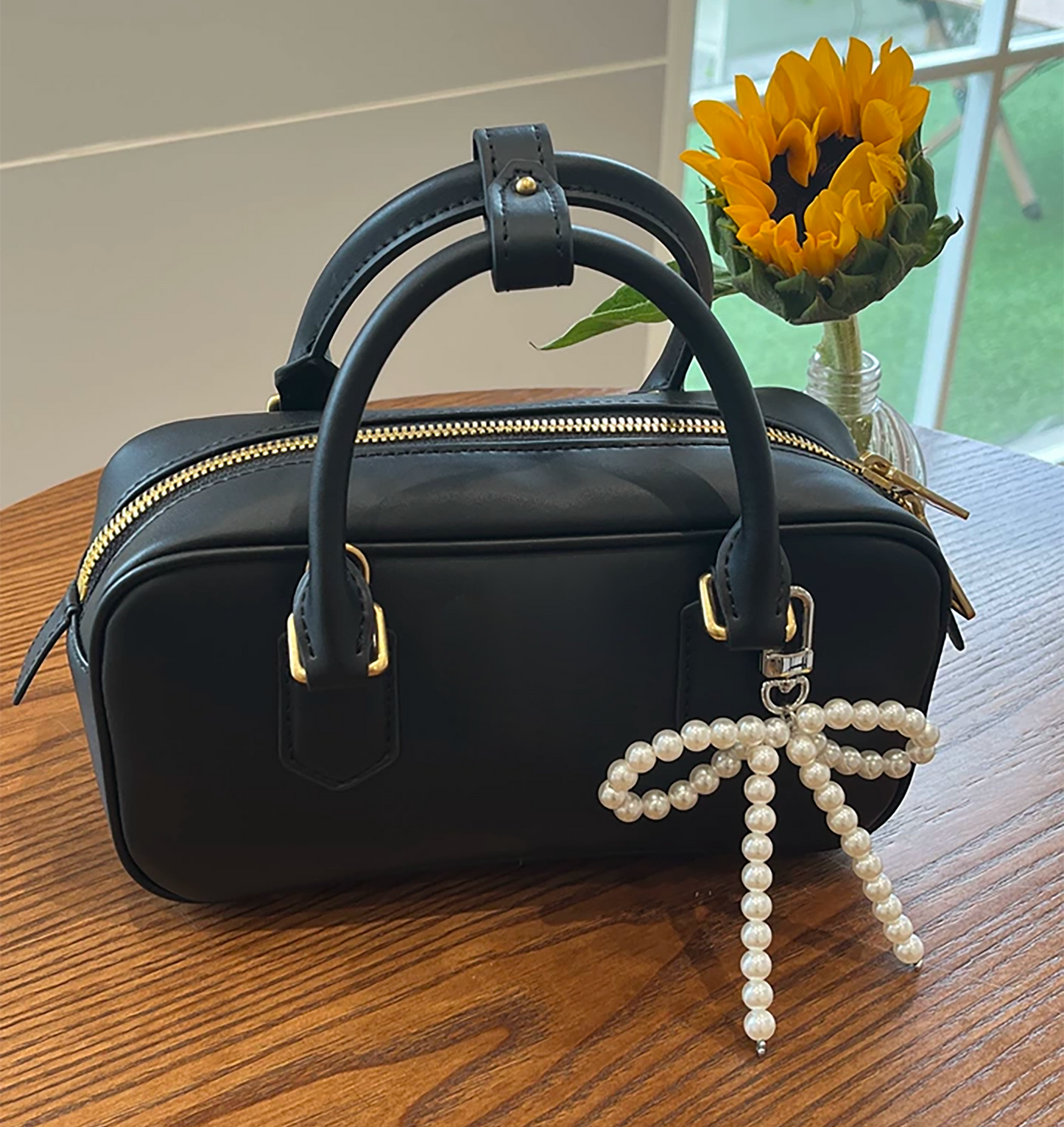 Arcadie matelassé nappa leather bag charm, pearl decorative accessory, bow-shaped keychain.